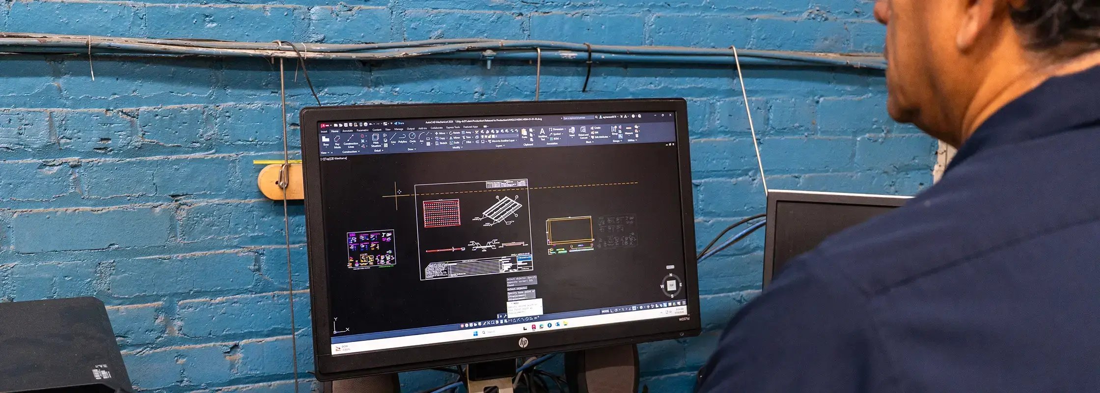 An employee at Franklin Display reviews digital files