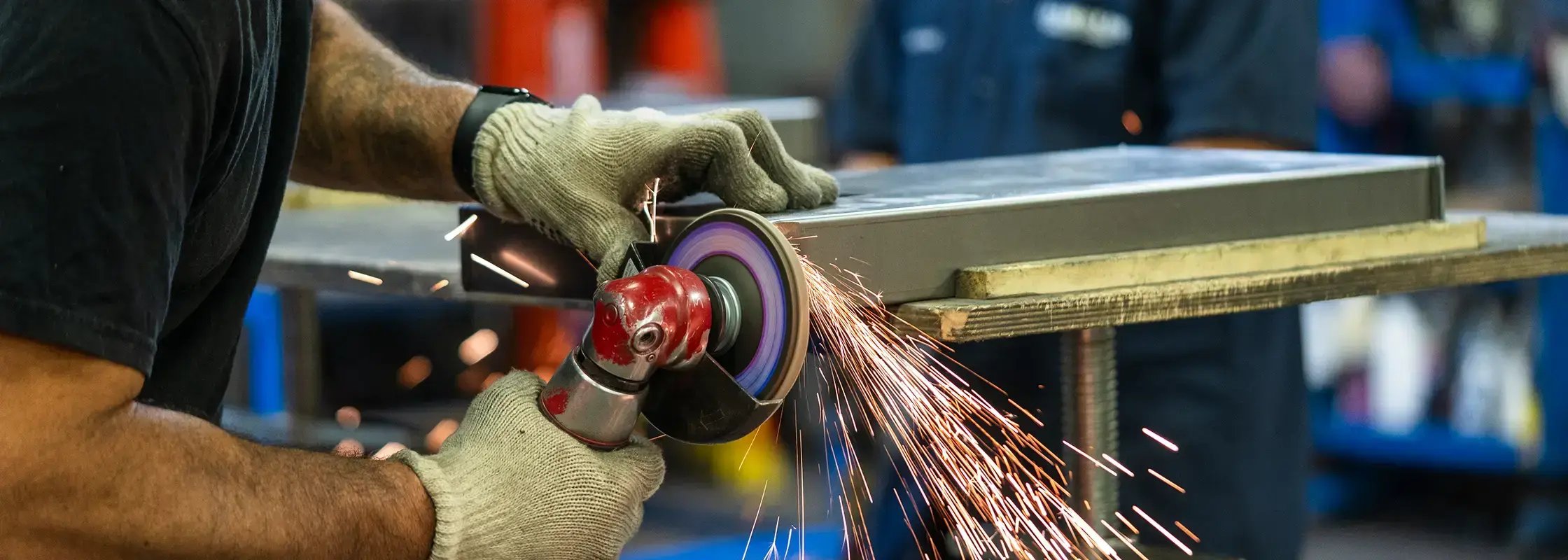 An employee at Franklin Display grinds a piece of a retail display