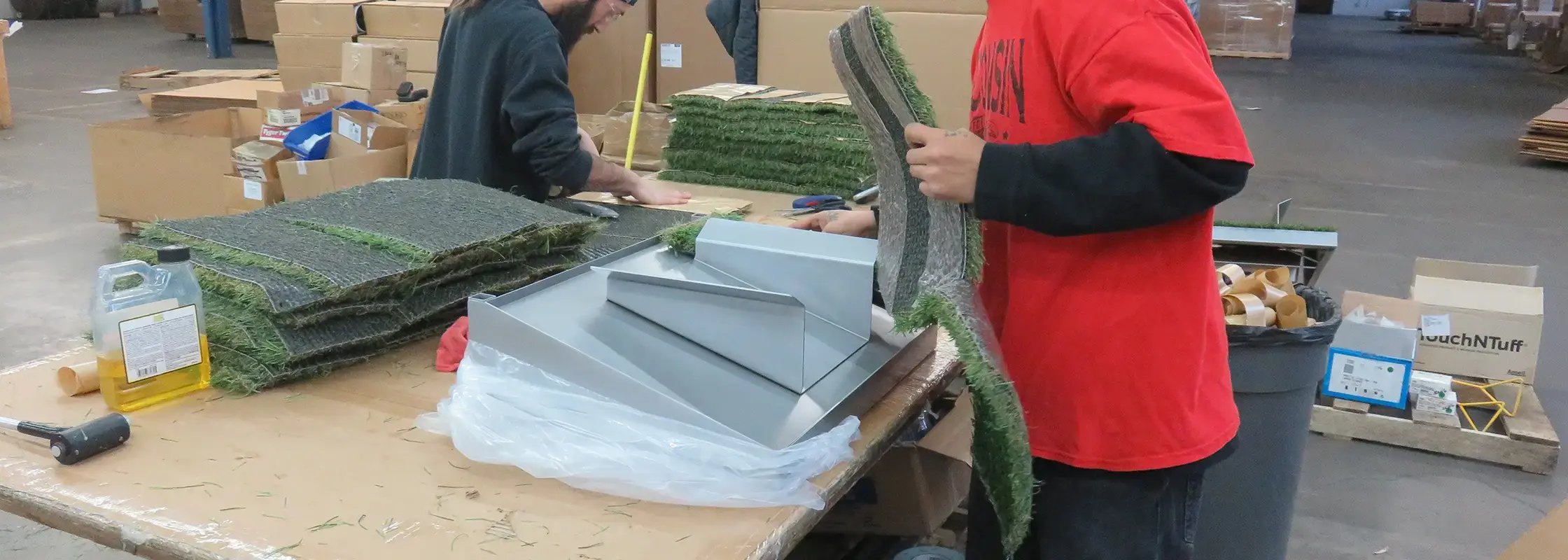Person creating a custom product display using astroturf