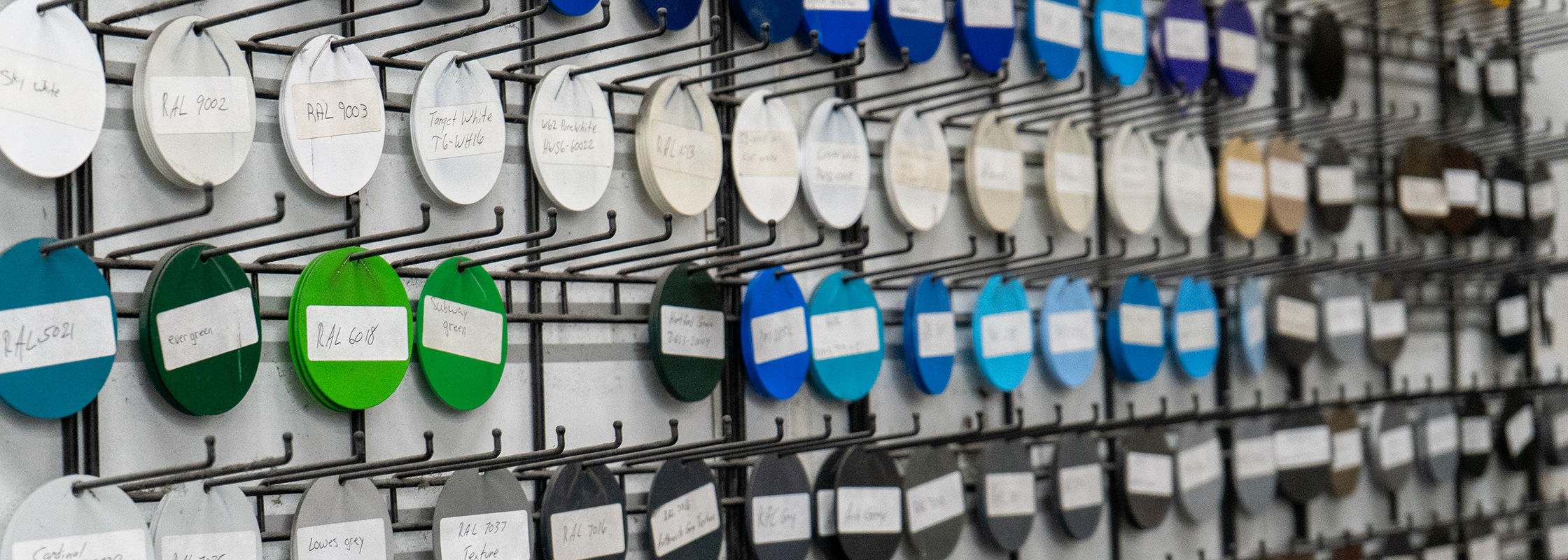 color swatches with their color ID on them hanging on a wall