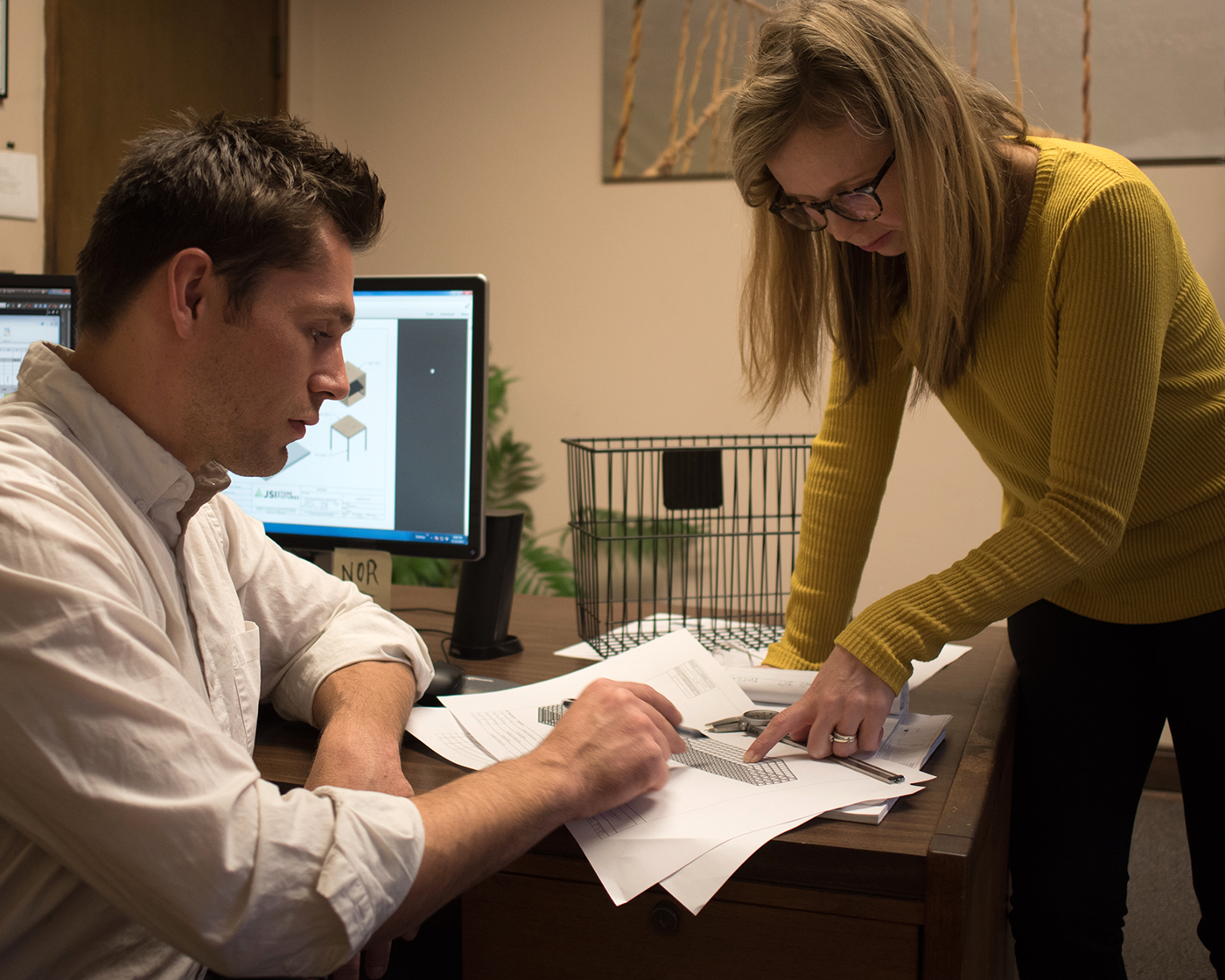 Two people looking over plans for a retail display prototype